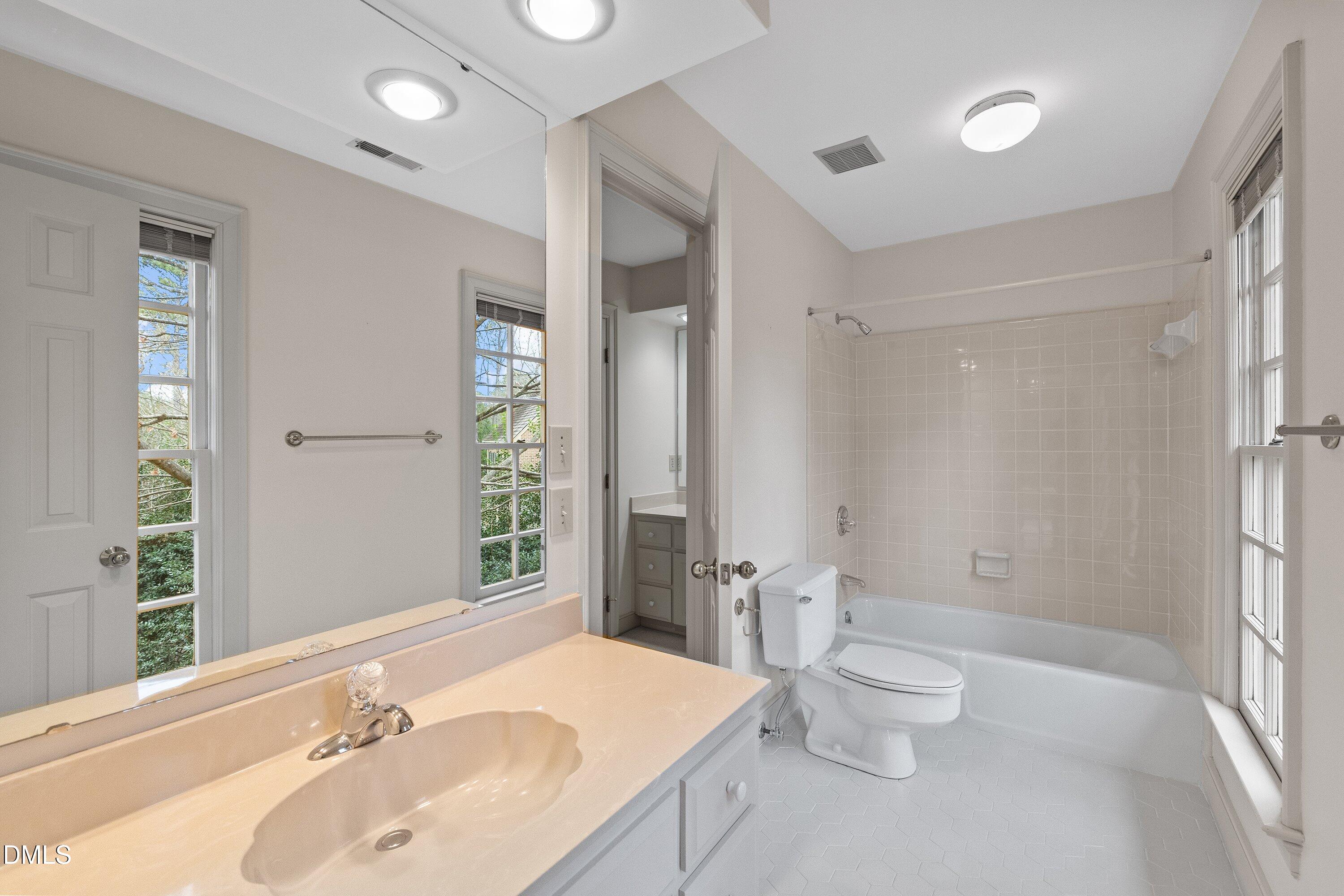 1708 Sawgrass Court Raleigh, NC 27615 - Photo 47 of 60 a bathroom with a sink and a large mirror