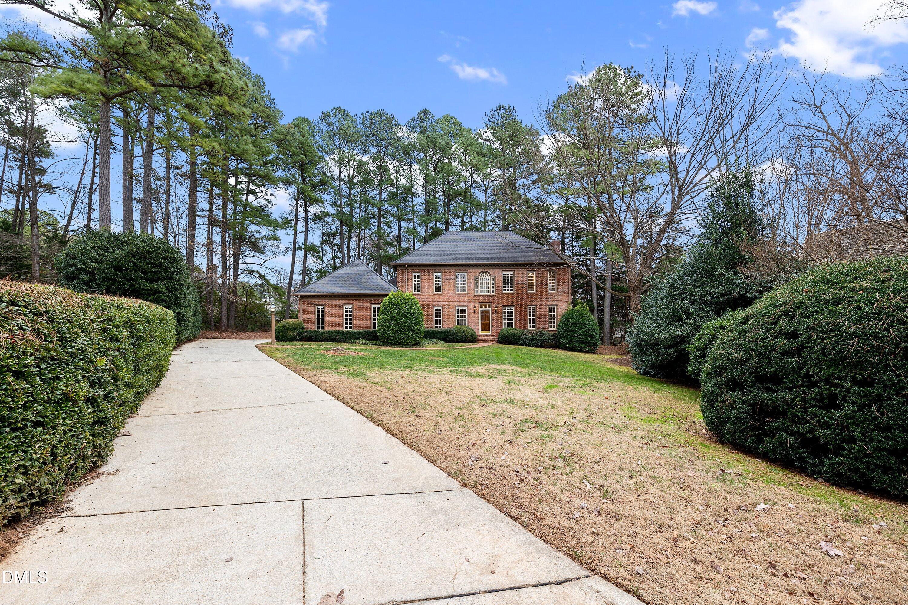 1708 Sawgrass Court Raleigh, NC 27615 - Photo 56 of 60 a front view of a house with a yard and trees