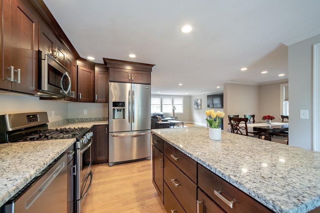 7 Peter Road North Reading, MA 01864 - Photo 13 of 32 a kitchen with stainless steel appliances granite countertop a sink stove and refrigerator