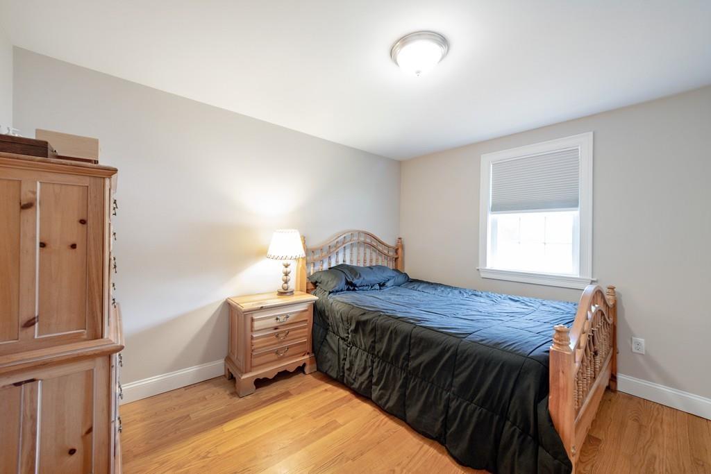 7 Peter Road North Reading, MA 01864 - Photo 19 of 32 a bedroom with a bed and wooden floor