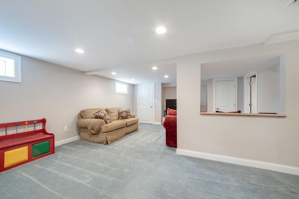 7 Peter Road North Reading, MA 01864 - Photo 23 of 32 a living room with furniture and a wooden floor