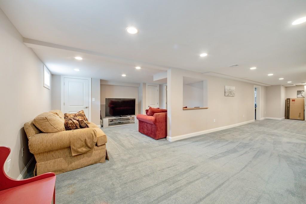 7 Peter Road North Reading, MA 01864 - Photo 24 of 32 a living room with furniture and a flat screen tv