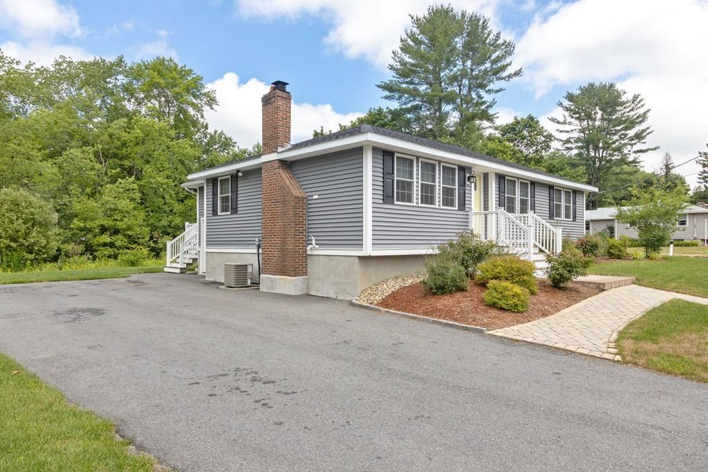 7 Peter Road North Reading, MA 01864 - Photo 31 of 32 a front view of a house with a yard and potted plants