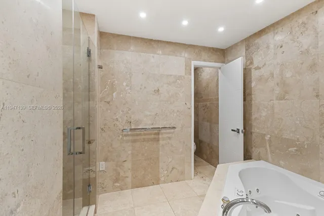 a bathroom with a bathtub and a shower