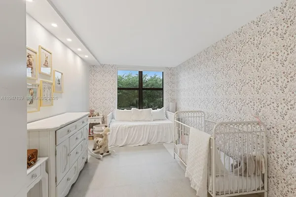 a spacious bedroom with a bed and a window