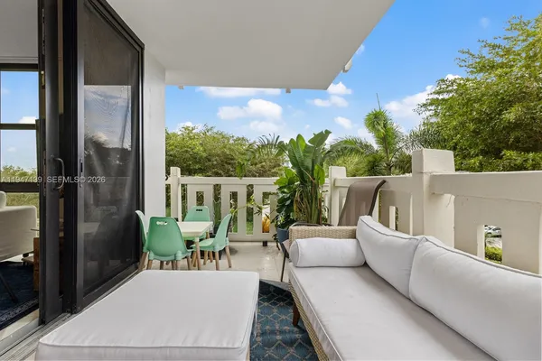 a balcony with furniture and a potted plant