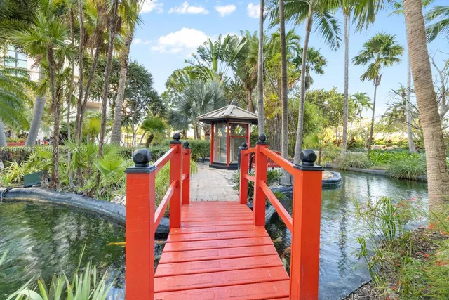 a view of swimming pool with a bench and trees