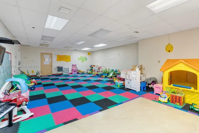 an aerial view of a house with a yard and large trees