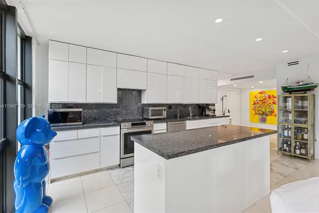 a kitchen with stainless steel appliances granite countertop a sink and a stove