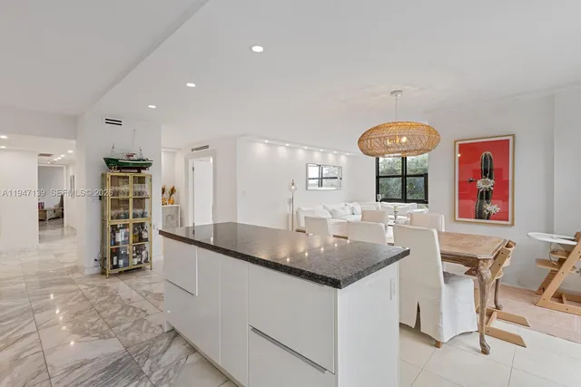 a kitchen with stainless steel appliances granite countertop a sink and a refrigerator