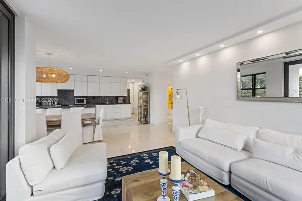 a living room with furniture and kitchen view