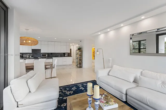 a living room with furniture and kitchen view