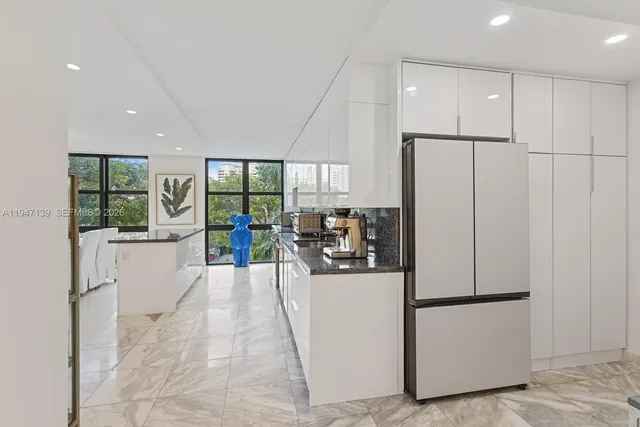 a view of a kitchen with a refrigerator and a stove