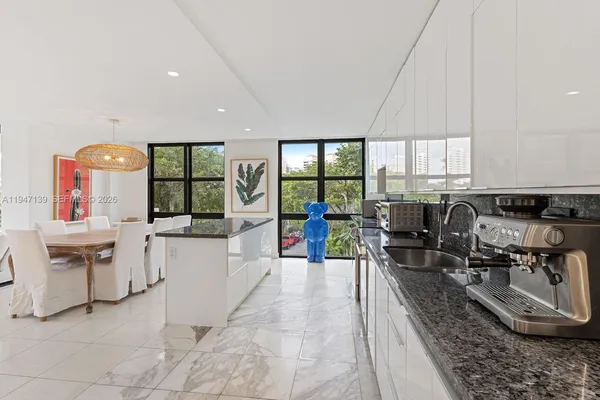 a living room with furniture a window and kitchen view