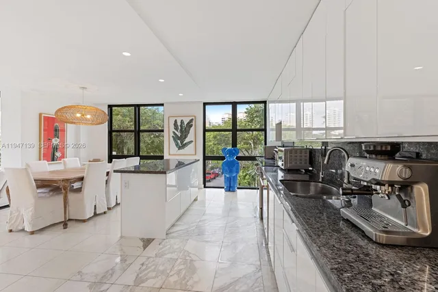a living room with furniture a window and kitchen view