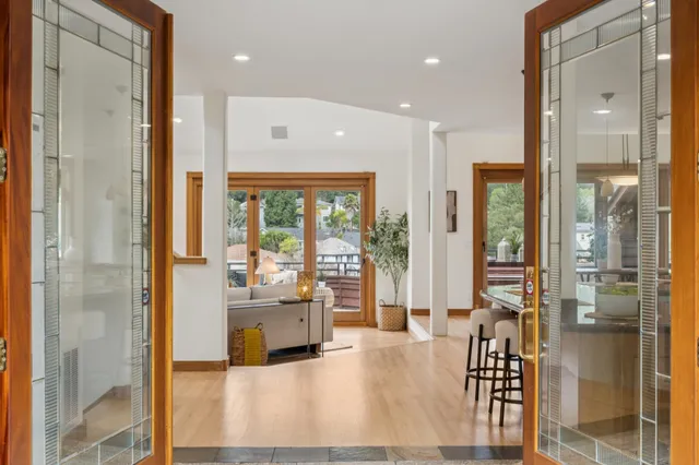 a large kitchen with a large counter top a sink a counter space and stainless steel appliances