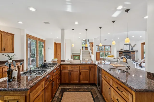 a view of a patio with dining table and chairs with couches and wooden floor