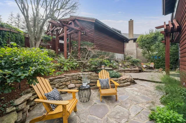 a view of a patio with table and chairs and potted plants