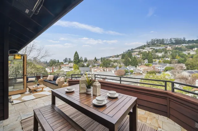 a living room with furniture kitchen view and a large window