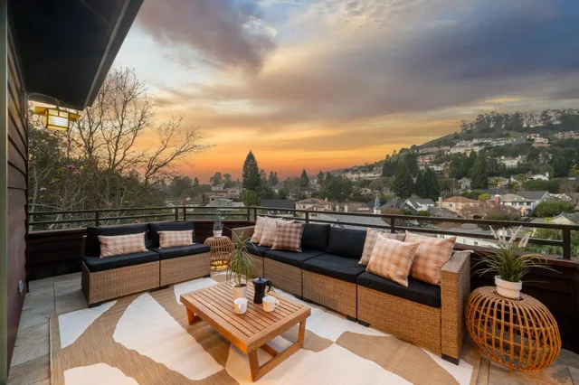 a dining room with furniture and a floor to ceiling window