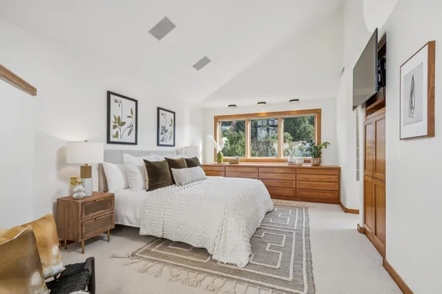 a living room with furniture and floor to ceiling windows
