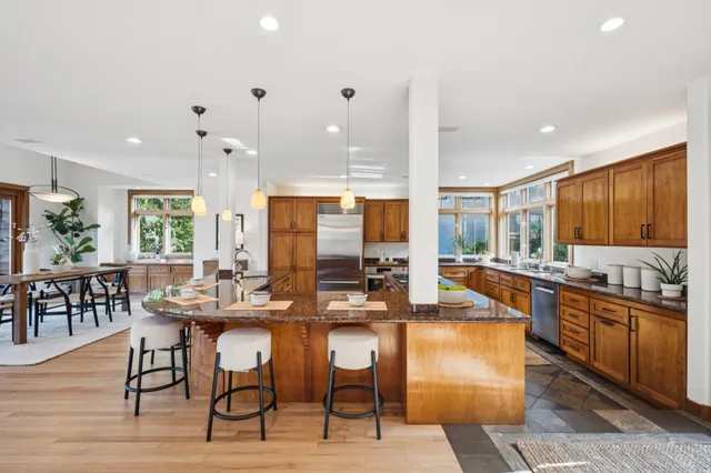a kitchen with lots of counter top space and dining table
