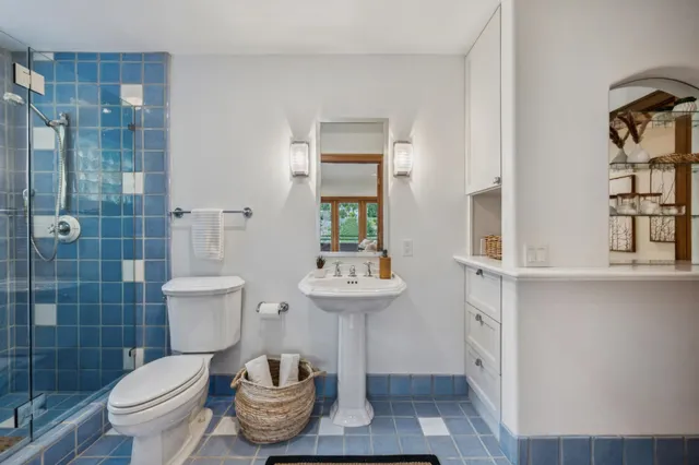 an aerial view of a house with balcony and trees al around