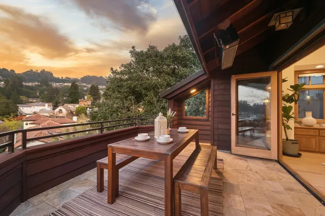 a view of a backyard with furniture and a garden