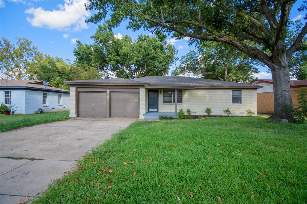 a front view of a house with a garden and yard