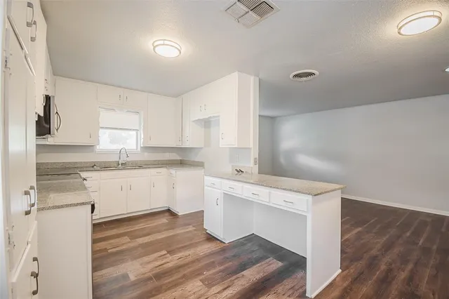 a kitchen with a sink stove and cabinets