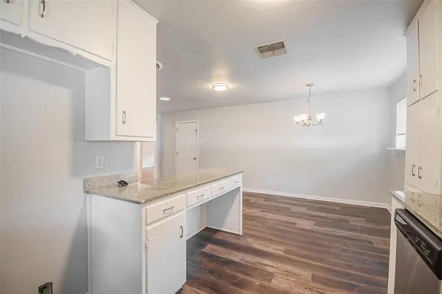 a room with a sink cabinets and wooden floor