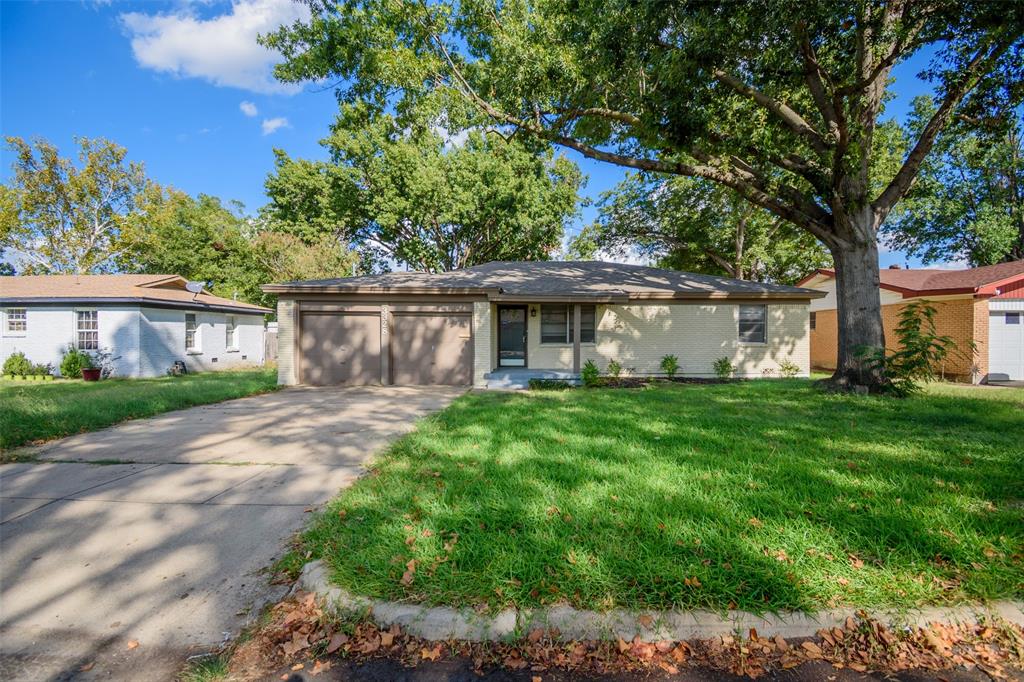 3328 Hedrick Street Fort Worth, TX 76111 - Photo 24 of 28 a front view of a house with a yard and potted plants