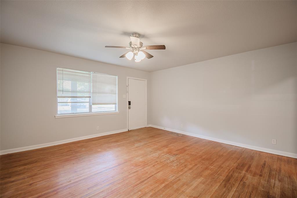 3328 Hedrick Street Fort Worth, TX 76111 - Photo 6 of 28 a view of empty room with wooden floor and fan