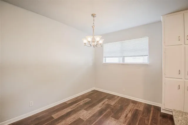 a view of a room with wooden floor and windows