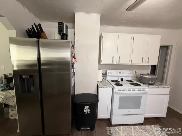 a kitchen with stainless steel appliances a refrigerator a stove a sink and a refrigerator