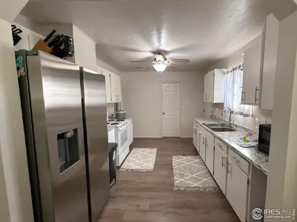 a kitchen with stainless steel appliances a refrigerator a sink a stove and island