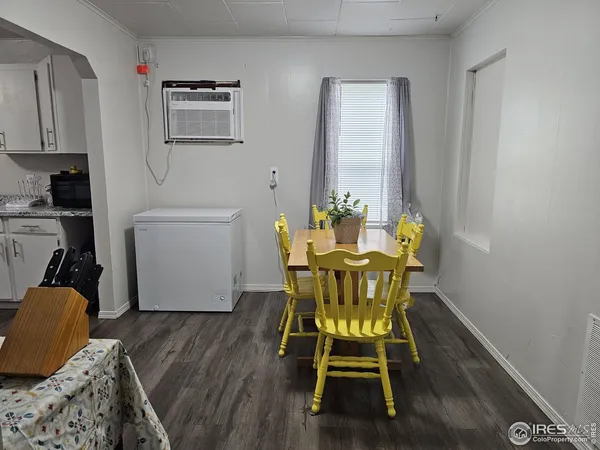 a dining room with furniture and wooden floor