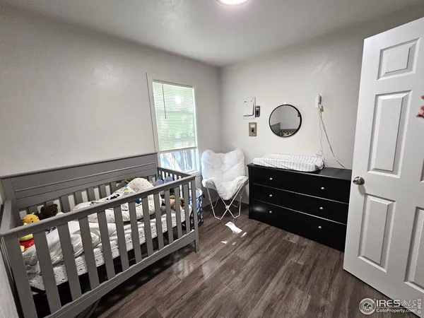 a bed room with a bed and a mirror