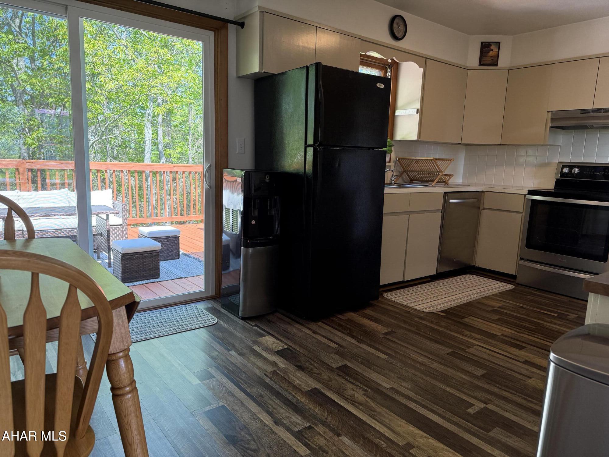 473 Calhoun Road Everett, PA 15537 - Photo 20 of 45 a kitchen with stainless steel appliances wooden floors and wooden cabinets