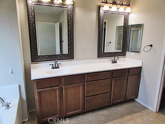 10918 Clover Circle Corona, CA 92883 - Photo 17 of 25 a bathroom with a double vanity sink and mirror