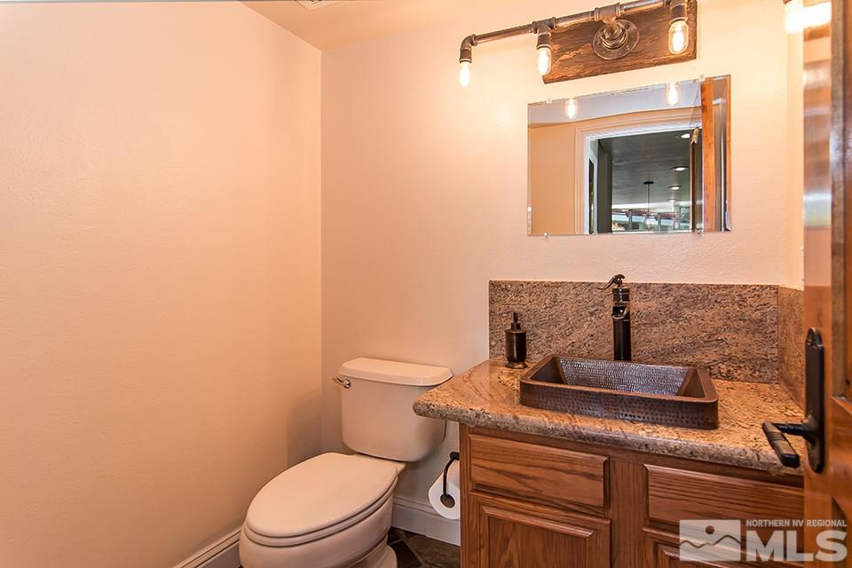 6120 Clover Meadows Court Reno, NV 89519 - Photo 11 of 21 a bathroom with a toilet a sink and mirror