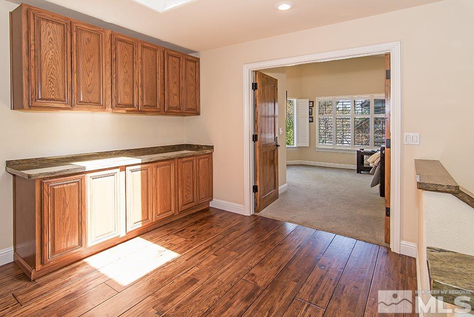 6120 Clover Meadows Court Reno, NV 89519 - Photo 12 of 21 a view of a kitchen with wooden floor and furniture