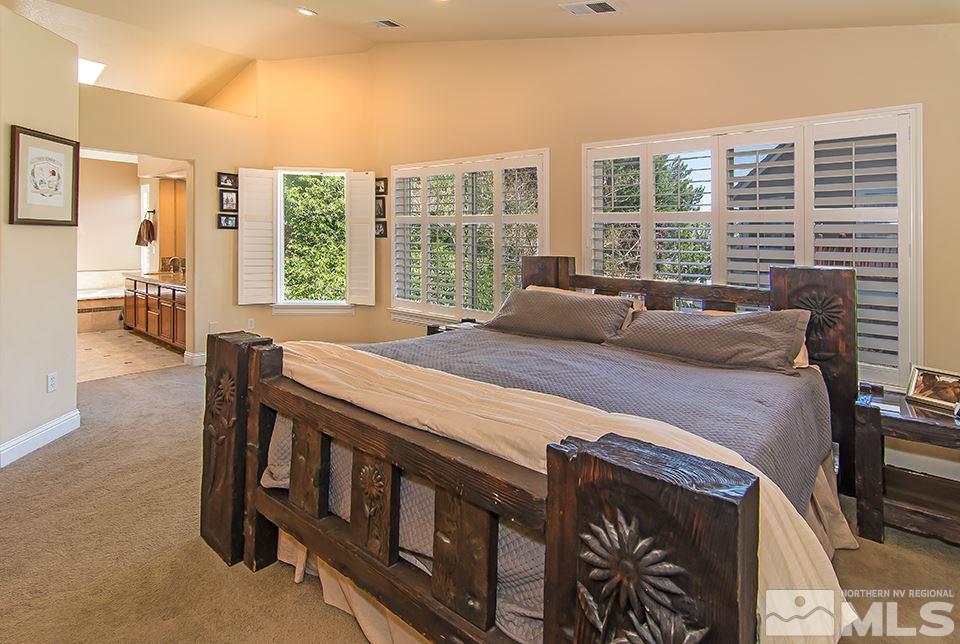 6120 Clover Meadows Court Reno, NV 89519 - Photo 13 of 21 a bed sitting in a bedroom next to a window
