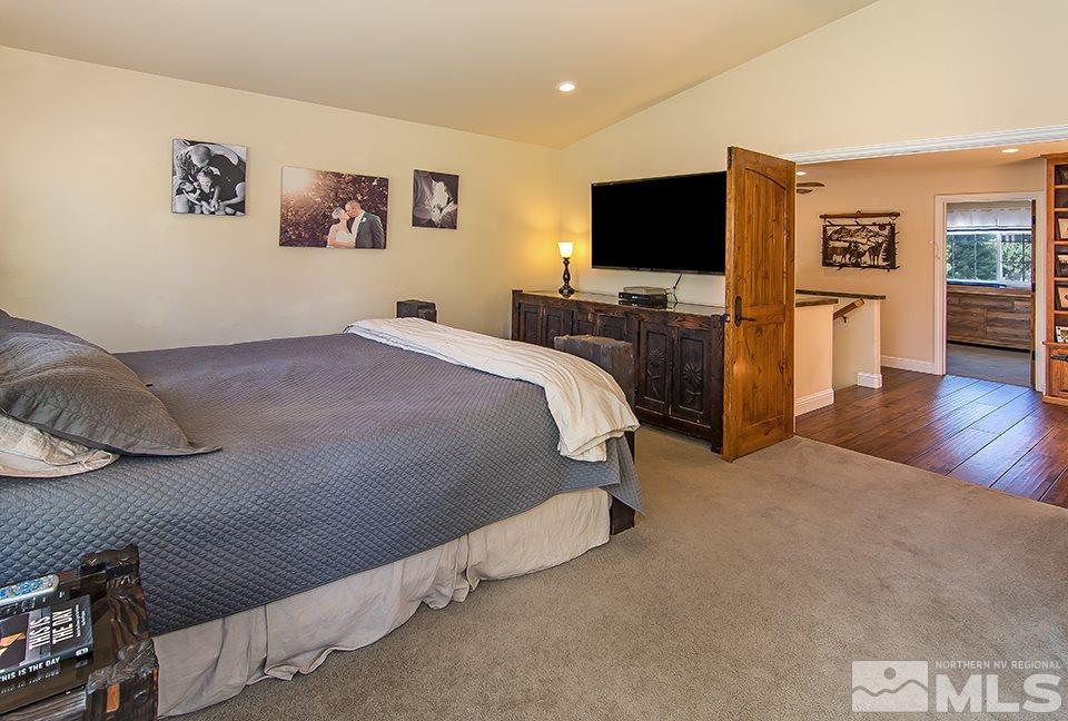 6120 Clover Meadows Court Reno, NV 89519 - Photo 14 of 21 a spacious bedroom with a bed and a flat screen tv