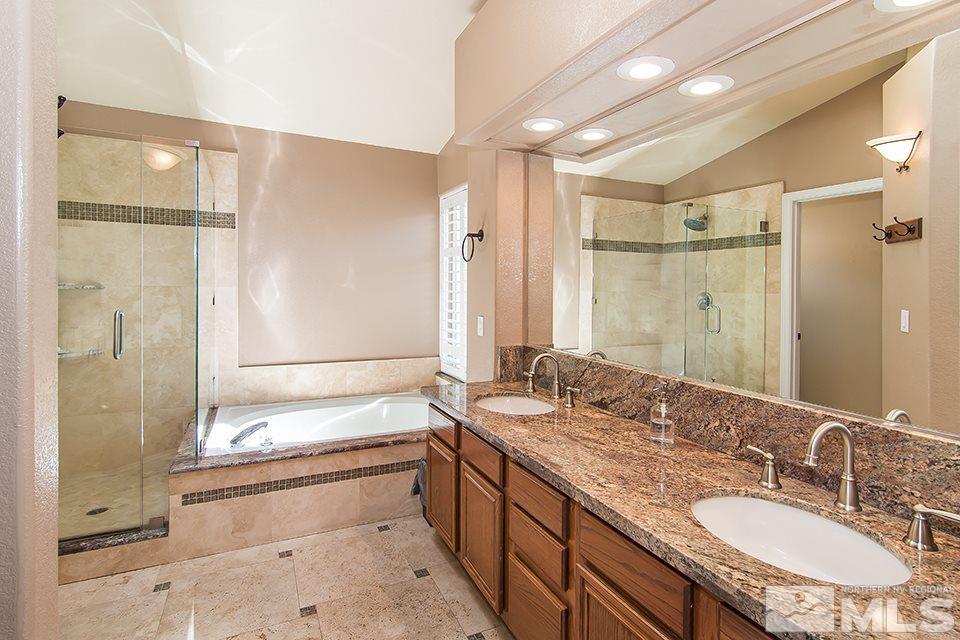 6120 Clover Meadows Court Reno, NV 89519 - Photo 15 of 21 a bathroom with a granite countertop sink mirror and a shower