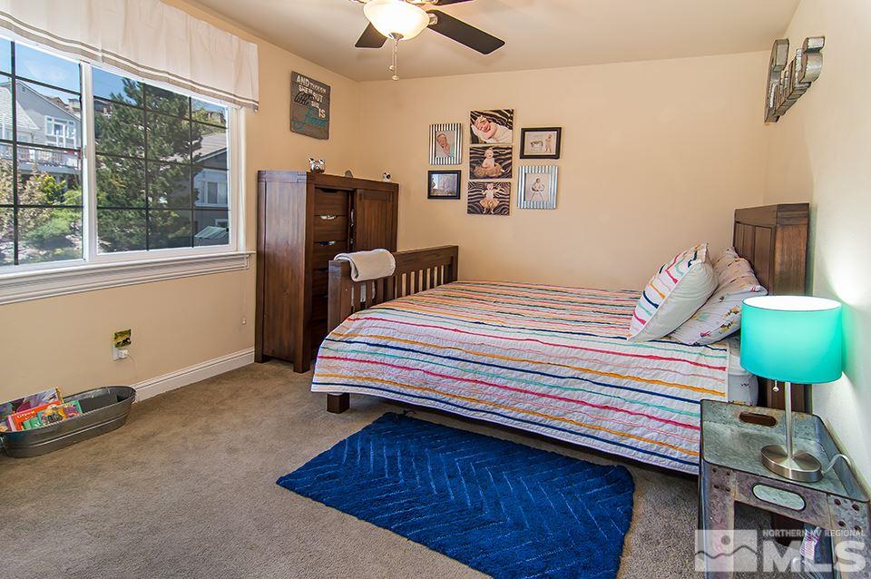 6120 Clover Meadows Court Reno, NV 89519 - Photo 16 of 21 a bedroom with a bed dresser and a window