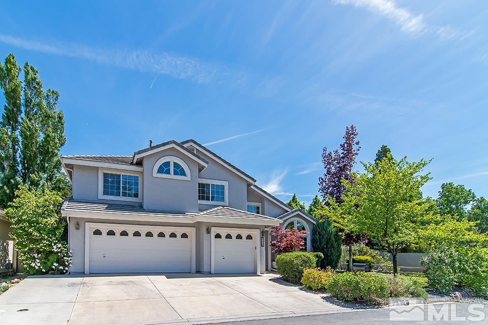 6120 Clover Meadows Court Reno, NV 89519 - Photo 2 of 21 a front view of a house with a garden