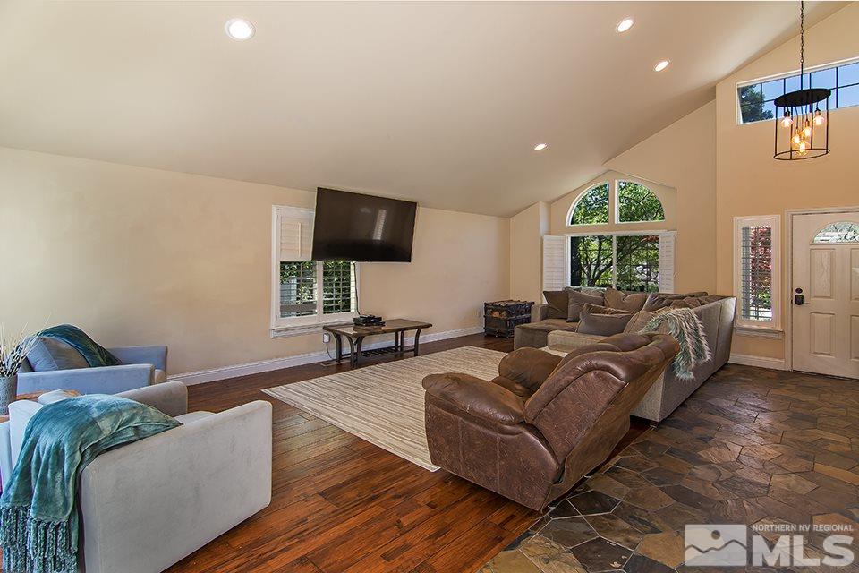 6120 Clover Meadows Court Reno, NV 89519 - Photo 5 of 21 a living room with furniture a large window and a flat screen tv