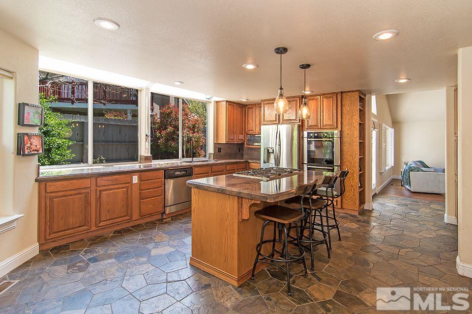6120 Clover Meadows Court Reno, NV 89519 - Photo 8 of 21 a kitchen with a table chairs sink and cabinets
