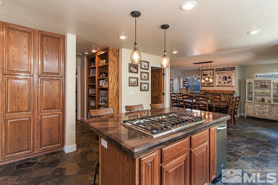 6120 Clover Meadows Court Reno, NV 89519 - Photo 10 of 21 a kitchen with stainless steel appliances granite countertop a stove a refrigerator and a wooden cabinets